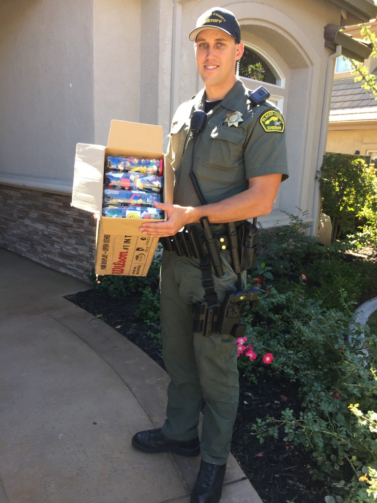 Deputy Sheriff Brandon Cecchetini accepting BrickDreams LEGO donation. 9/26/2015